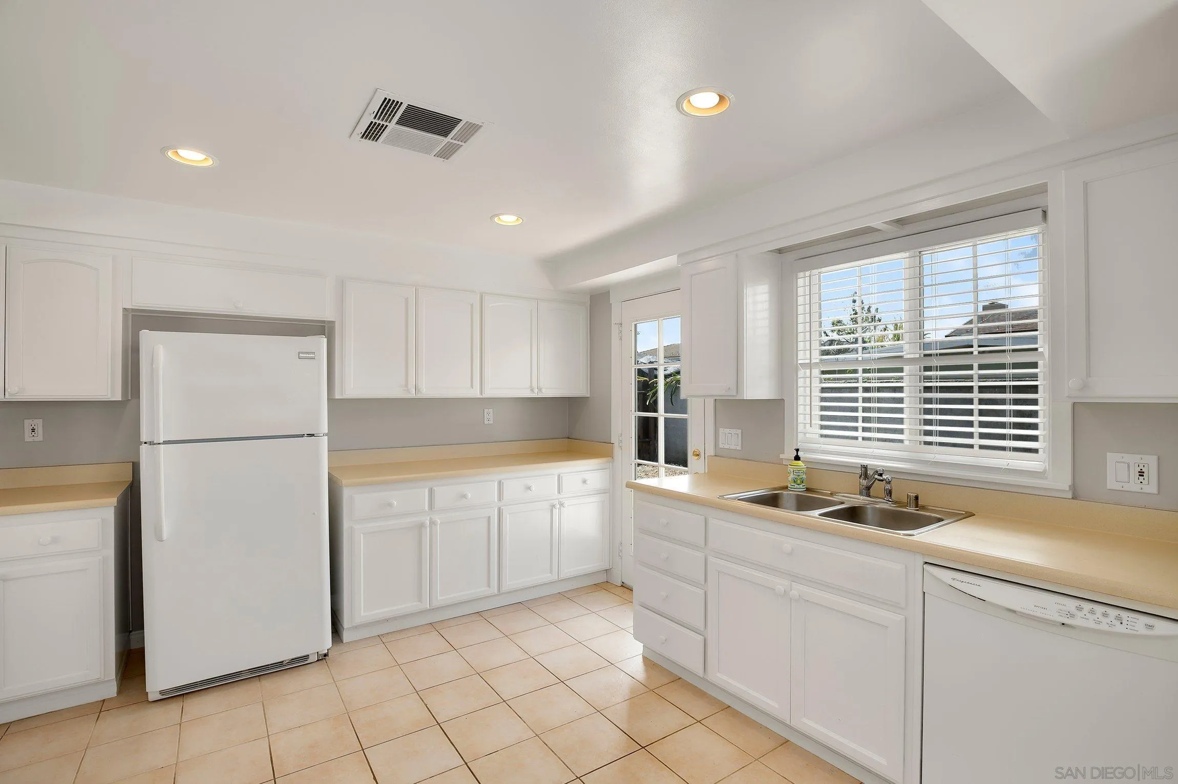 13647 Somerset Road Poway, CA 92064 - Photo 10 of 25 a kitchen with sink refrigerator and cabinets