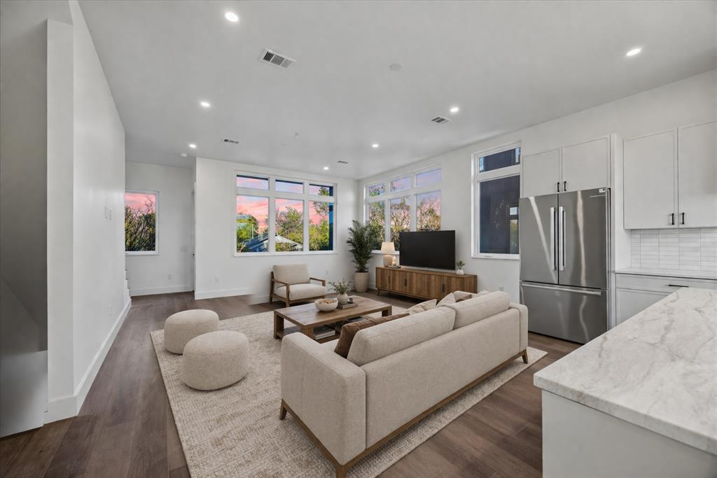 4101 Menchaca Road, Unit 102 Austin, TX 78704 - Photo 3 of 14 An open concept living area boasts rich hardwood flooring and abundant natural light from large windows.