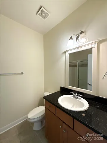 a bathroom with a sink a toilet and mirror