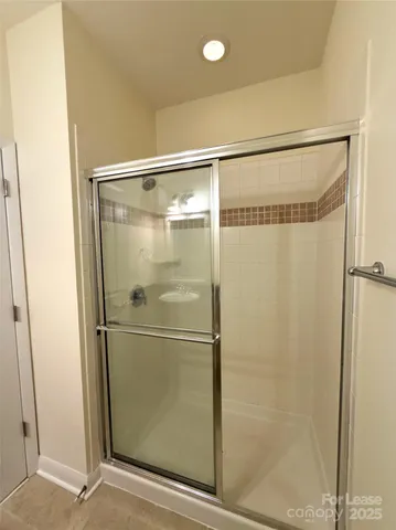 a bathroom with a glass shower door