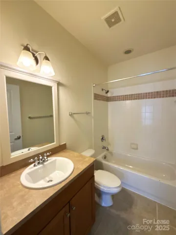 a bathroom with a sink toilet a mirror and shower