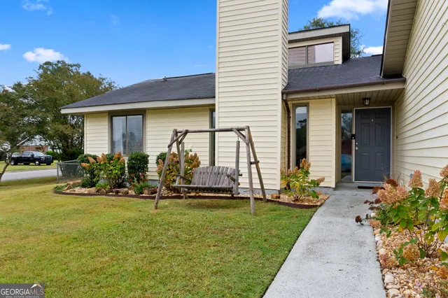 a front view of a house with garden