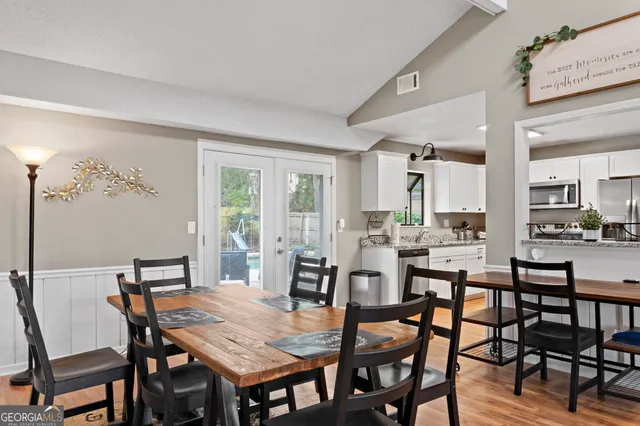 a view of a dining room with furniture and wooden floor