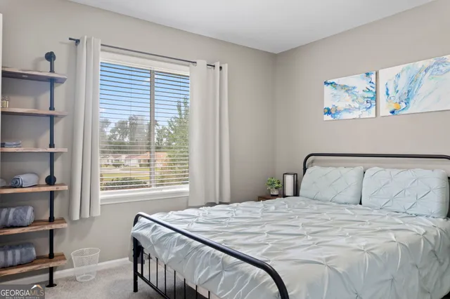 a bedroom with a bed and a flat tv screen in it