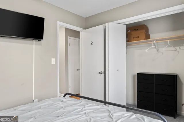 a bedroom with a bed and a closet