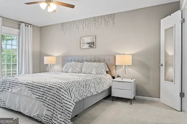 a bedroom with a large bed and a chandelier