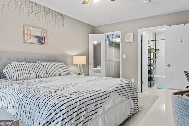 a bedroom with a bed and a large window