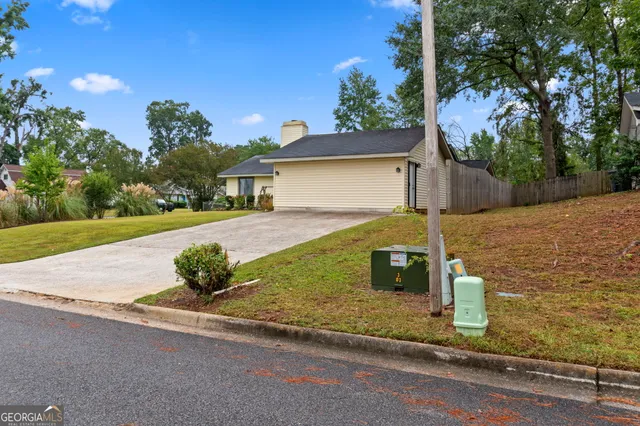 a view of a house with a garden and yard