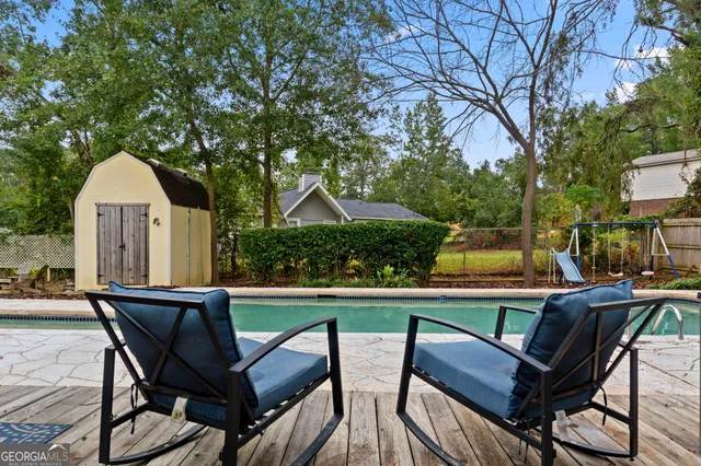 a view of a patio with couches and pool table and chairs