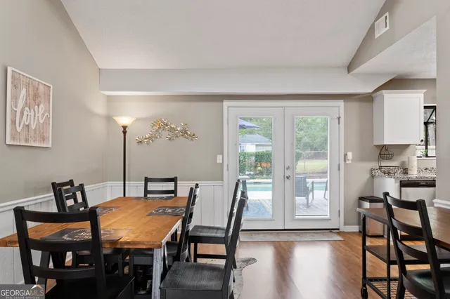 a view of a dining room with furniture and wooden floor