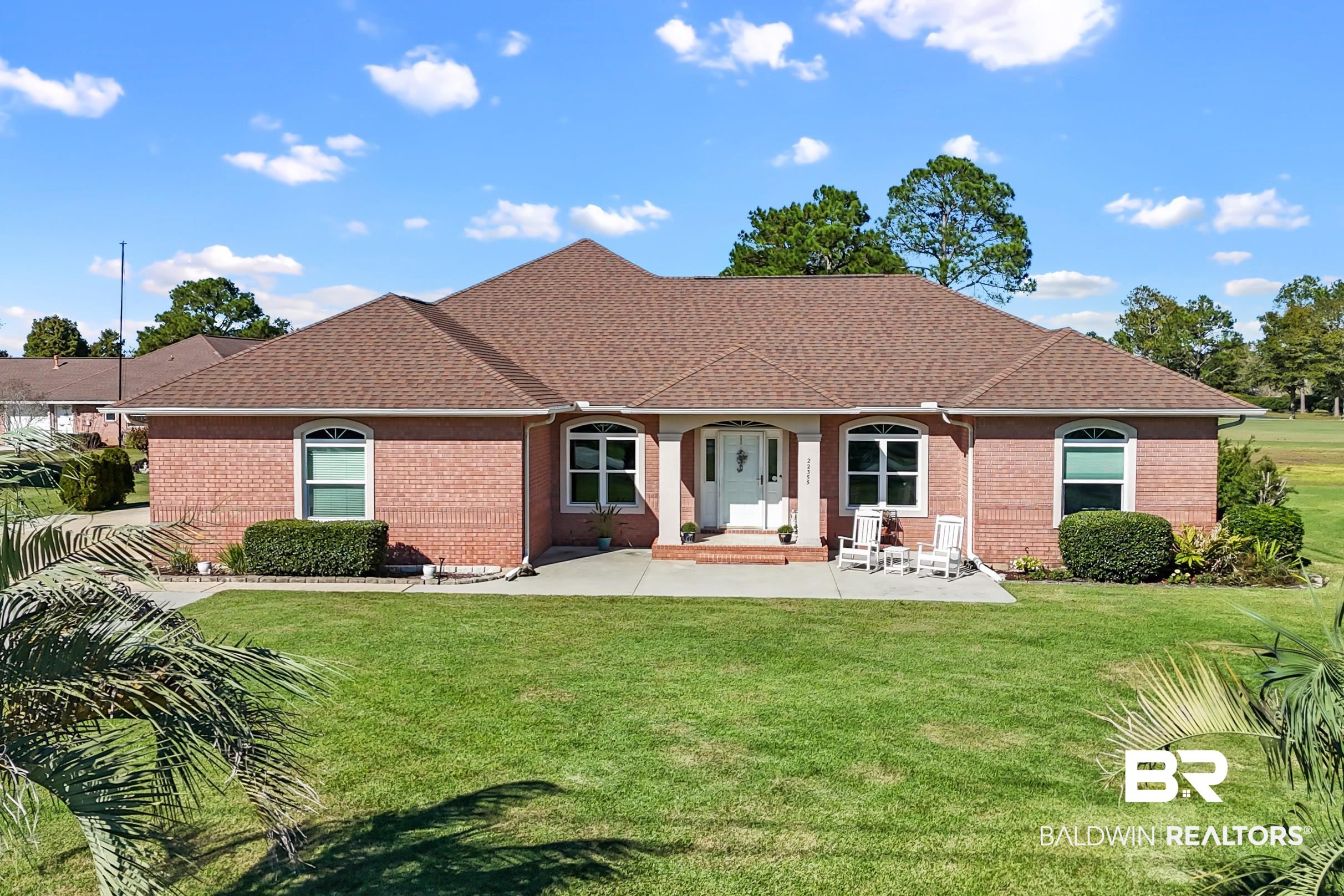 22355 East County Road 12 Foley, AL 36535 - Photo 1 of 54 View of front facade featuring roof with shingles, brick siding, a front yard, and covered porch