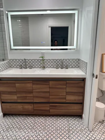 a kitchen with stainless steel appliances granite countertop a refrigerator stove and sink