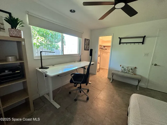 a bedroom with a bed a desk and chair