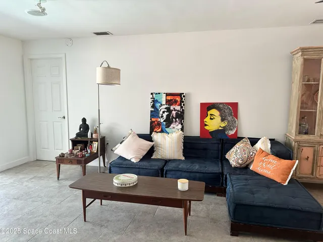 a large bed sitting in a bedroom next to a window