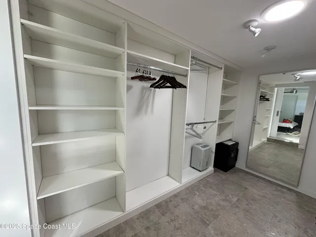 a view of a dining room with furniture a chandelier and wooden floor