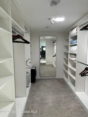 a bedroom with a bed and painting on the wall