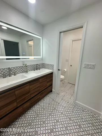 a view of a hallway with table and chair