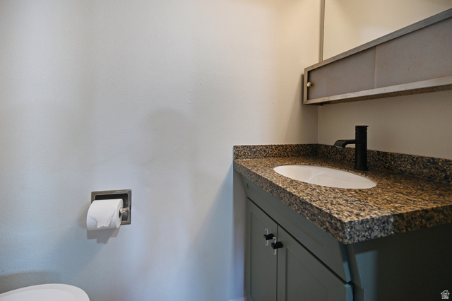 285 West 600 North, Unit 2 Logan, UT 84321 - Photo 18 of 21 Vanity with an integrated sink, granite-style countertop, and a matte black faucet
