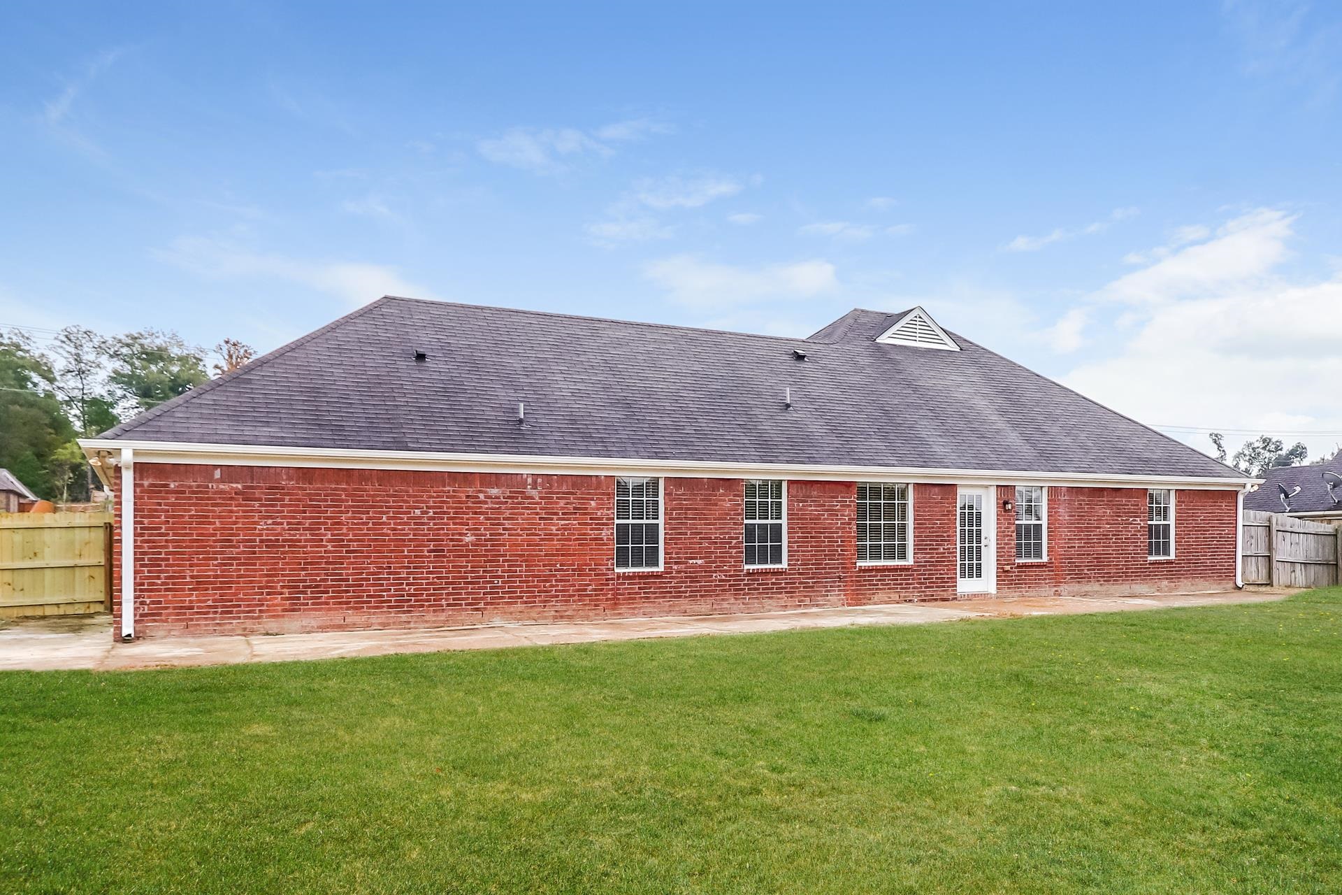 2415 North Forest Hill Irene Road Cordova, TN 38016 - Photo 14 of 16 Rear view of property featuring brick siding, a patio area, and a shingled roof
