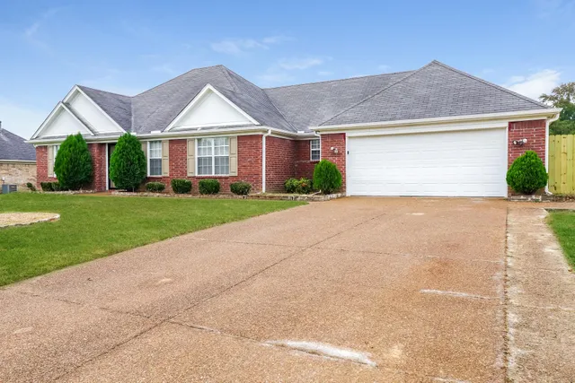 a view of a house next to a yard and road
