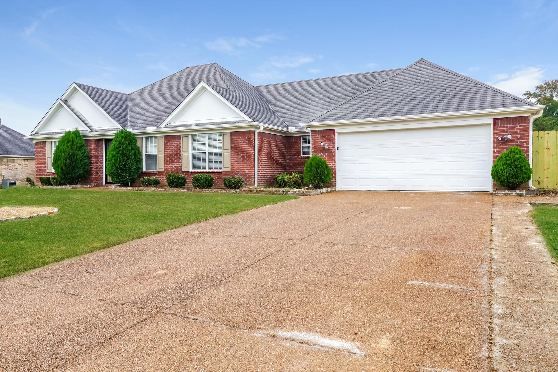 2415 North Forest Hill Irene Road Cordova, TN 38016 - Photo 2 of 16 View of front of home with driveway, a shingled roof, brick siding, and a front yard