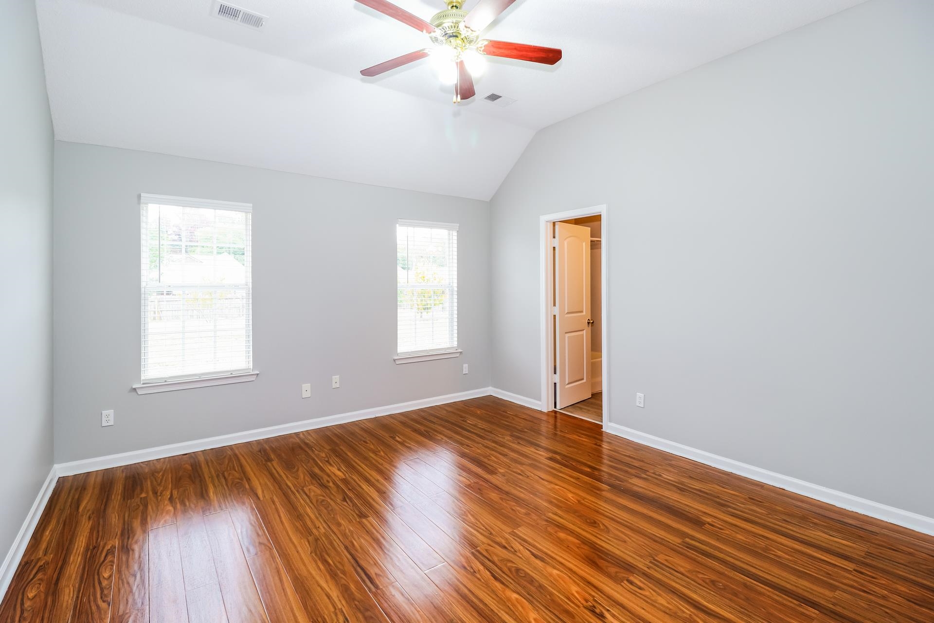 2415 North Forest Hill Irene Road Cordova, TN 38016 - Photo 8 of 16 Empty room with vaulted ceiling, wood finished floors, and ceiling fan