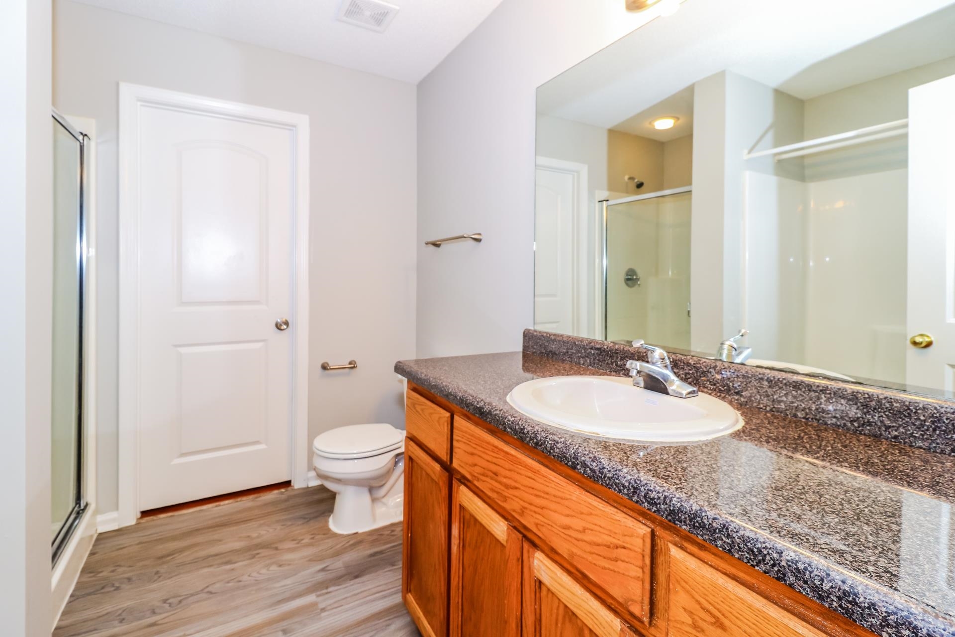 2415 North Forest Hill Irene Road Cordova, TN 38016 - Photo 9 of 16 Full bathroom with a stall shower, vanity, and light wood-style floors