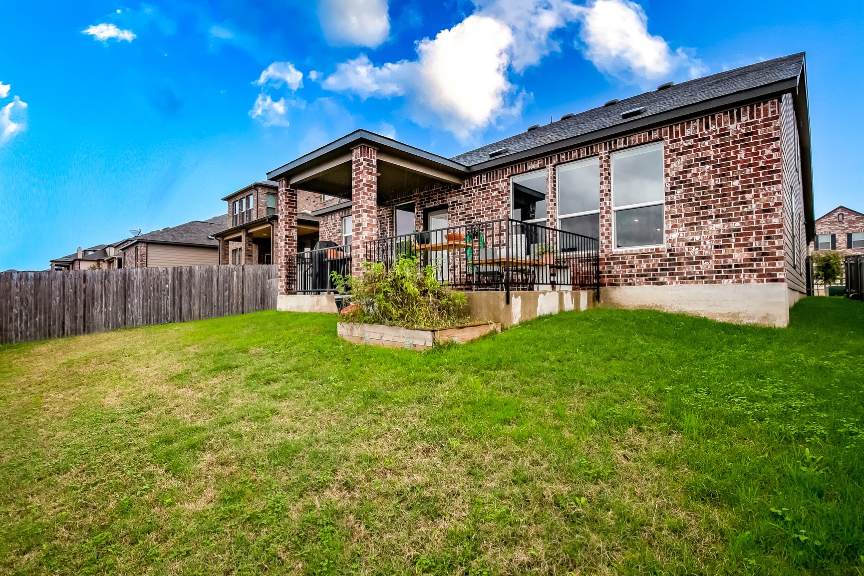 7616 Groundhog Way Austin, TX 78744 - Photo 33 of 34 a view of a house with a yard and sitting area