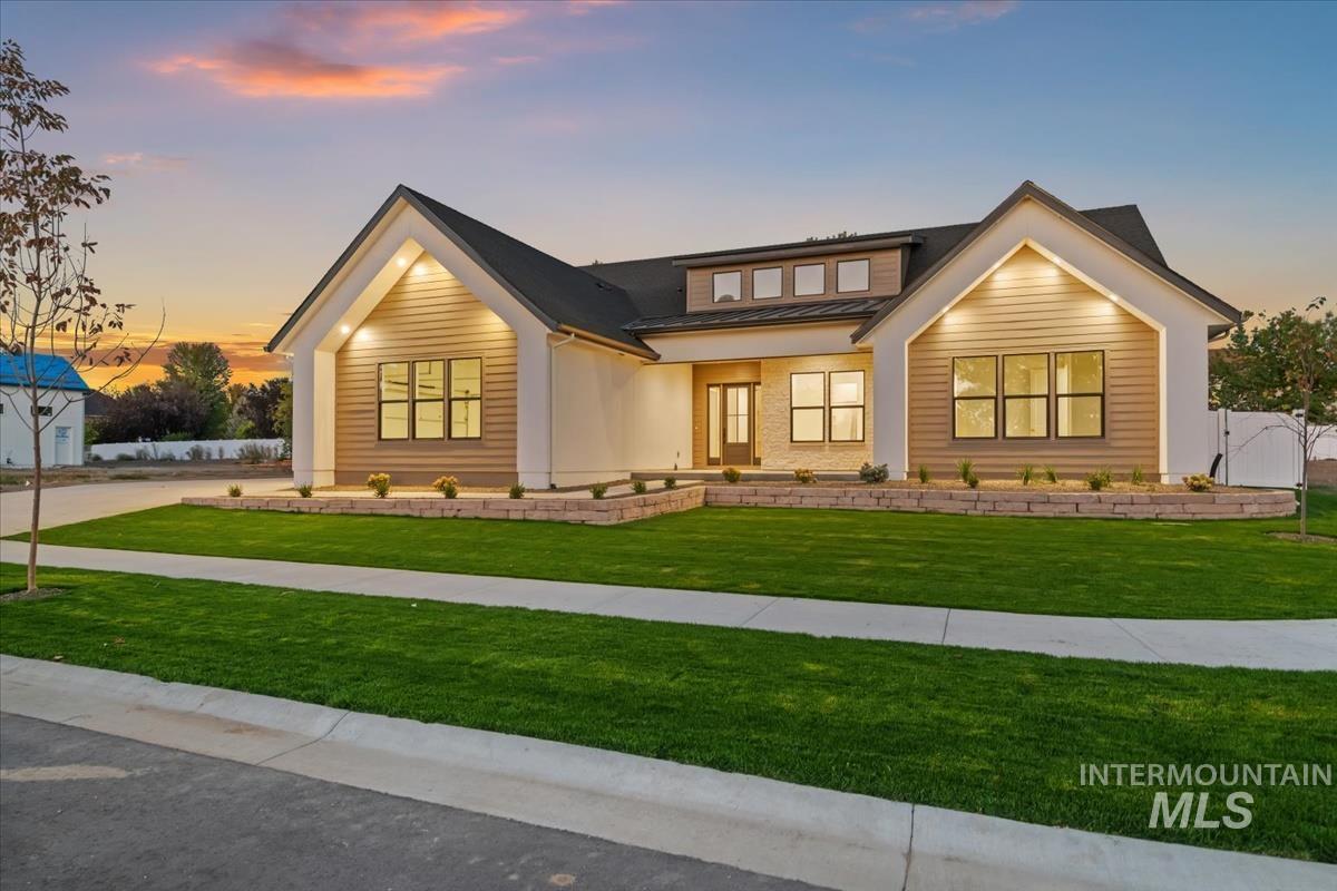 Modern farmhouse with a porch, a metal roof, and a standing seam roof
