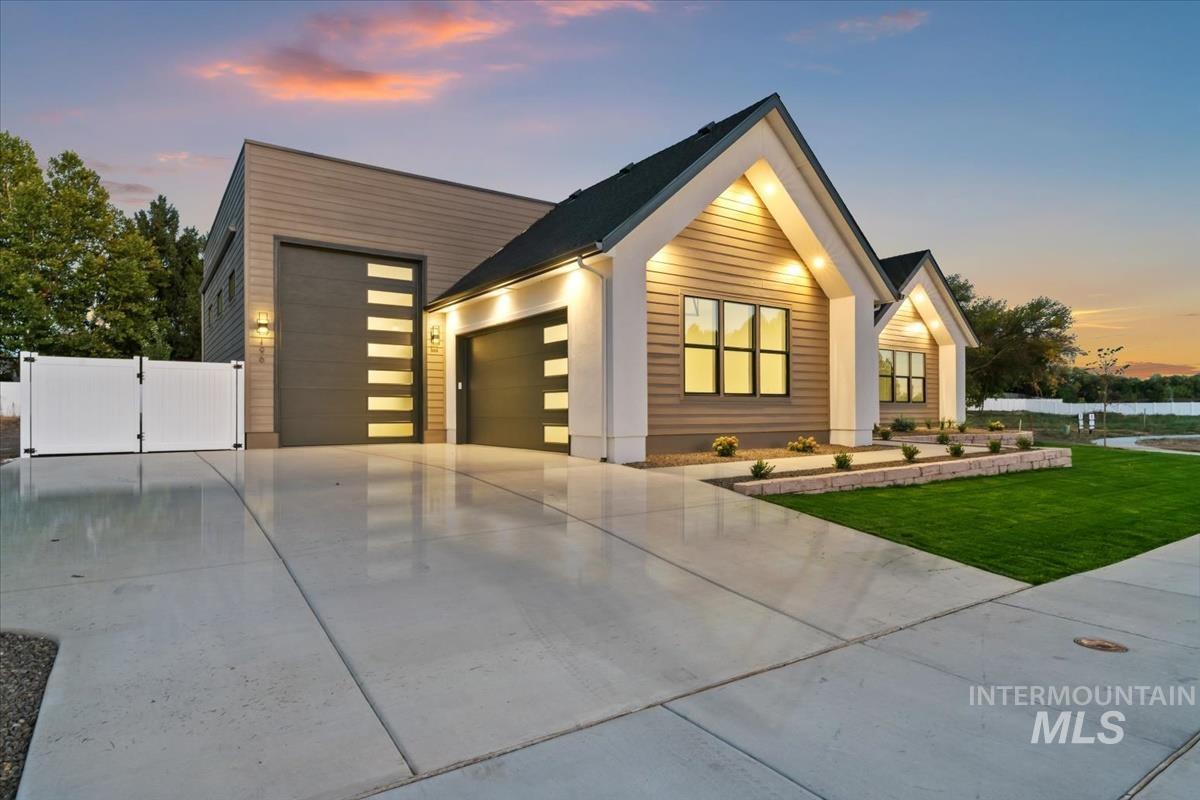 196 North Timber Wolf Place Eagle, ID 83616 - Photo 2 of 50 View of front facade with a gate, an attached garage, and driveway