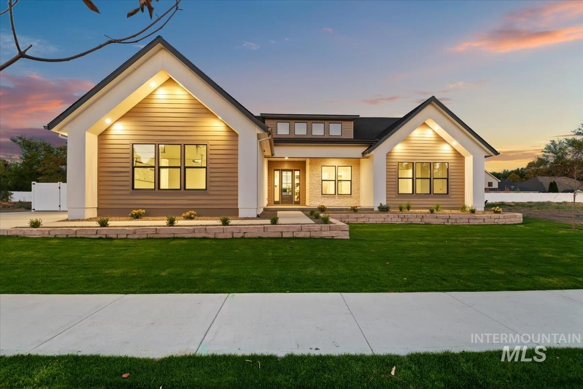 196 North Timber Wolf Place Eagle, ID 83616 - Photo 3 of 50 Modern inspired farmhouse with a porch and a lawn