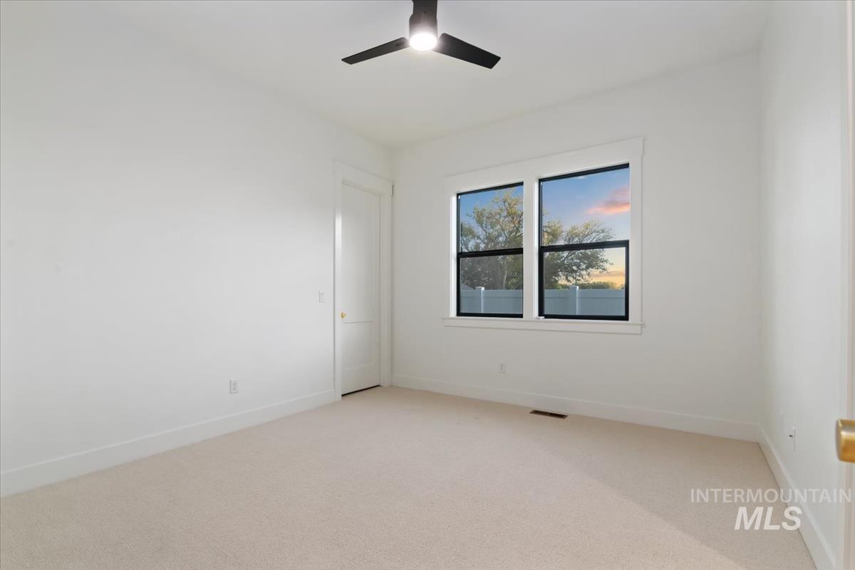 196 North Timber Wolf Place Eagle, ID 83616 - Photo 31 of 50 Unfurnished room featuring light carpet and a ceiling fan