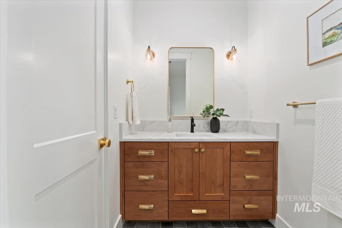 196 North Timber Wolf Place Eagle, ID 83616 - Photo 35 of 50 Bathroom with vanity and dark tile patterned floors