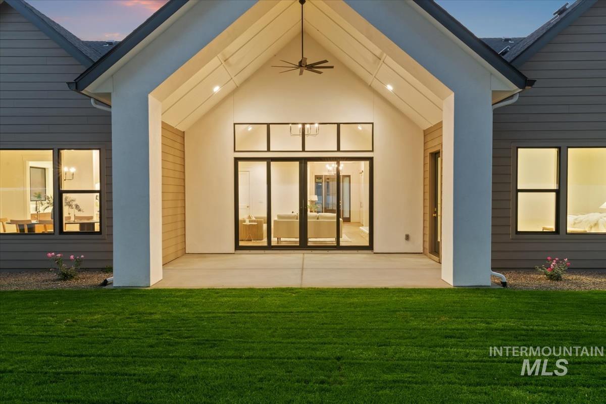 196 North Timber Wolf Place Eagle, ID 83616 - Photo 44 of 50 Rear view of house featuring a patio area, a lawn, and stucco siding