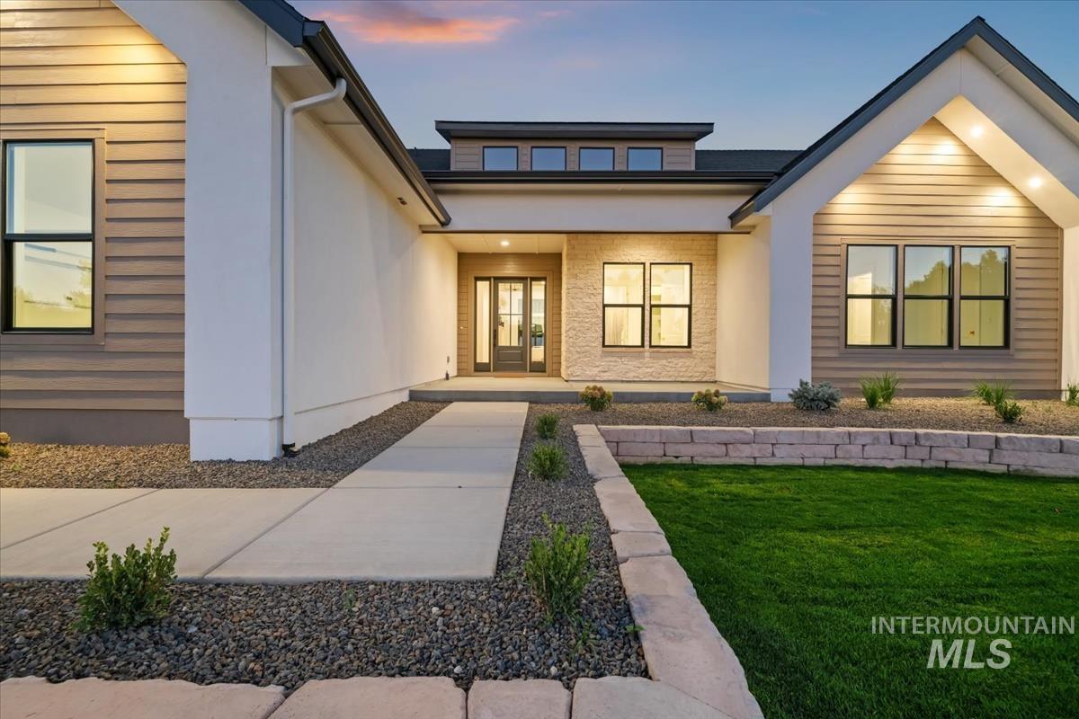 196 North Timber Wolf Place Eagle, ID 83616 - Photo 50 of 50 Entrance to property featuring a lawn and stucco siding