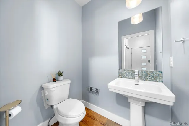 a bathroom with a sink a toilet and mirror