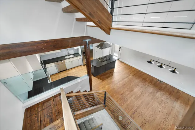 a view of staircase with lots of frames on wall and a potted plant