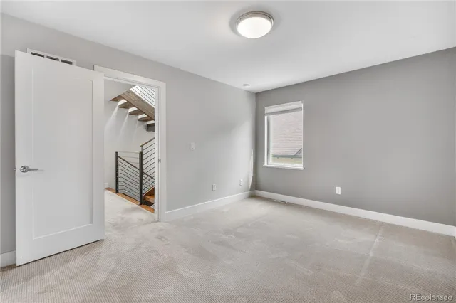 an empty room with windows and closet