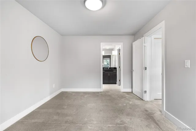 a view of a room with wooden floor and white walls