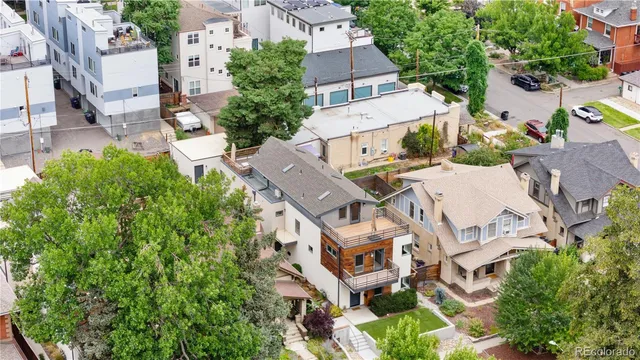 an aerial view of residential house with outdoor space and trees all around