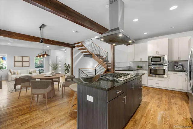 a kitchen with stainless steel appliances granite countertop a stove oven and a refrigerator