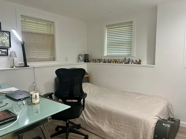 a bedroom with a bed a table and chair