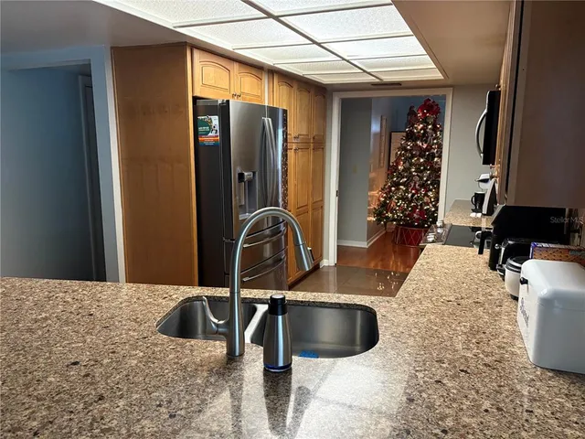 a kitchen with a sink and a refrigerator