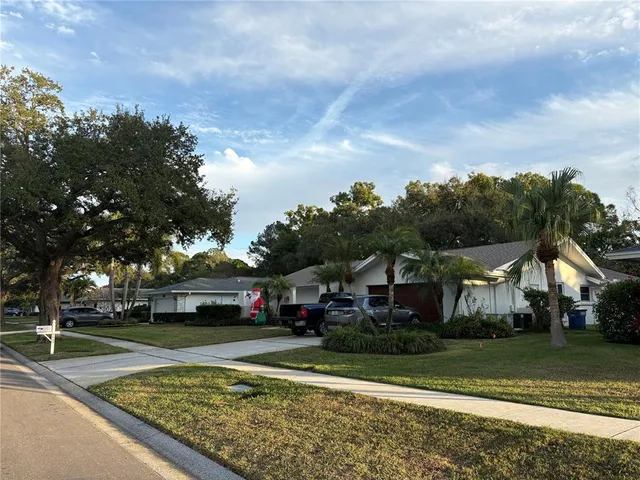 a view of a town with barn house in the background