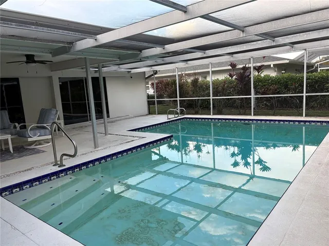 a view of a backyard with a swimming pool