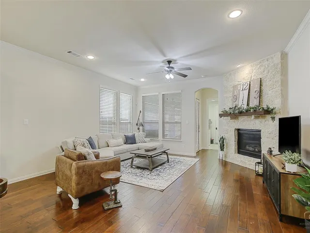 a living room with furniture a fireplace and a flat screen tv
