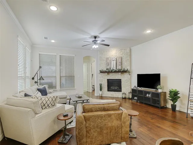 a living room with furniture a fireplace and a flat screen tv