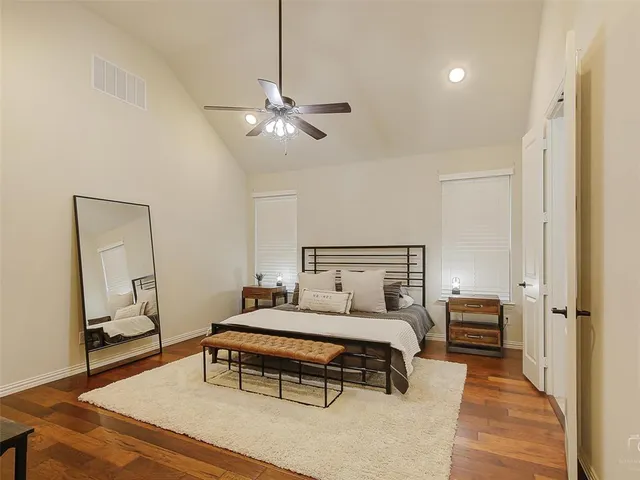 a bedroom with a bed and a chandelier