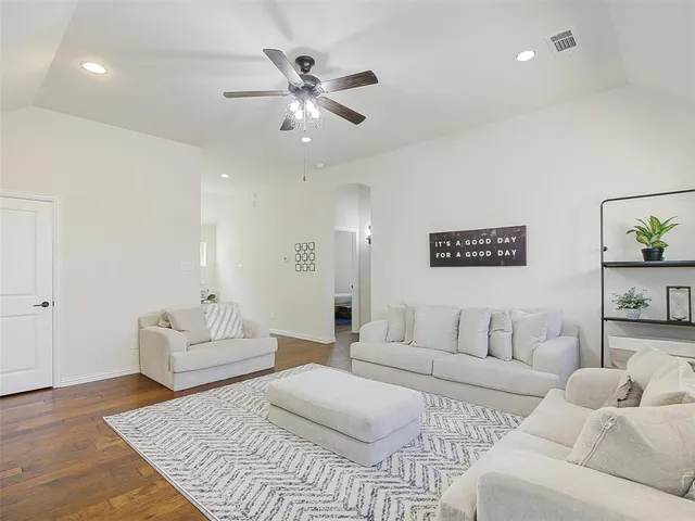 a spacious bedroom with a bed and ceiling fan
