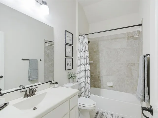 a bathroom with a sink mirror toilet and bathtub